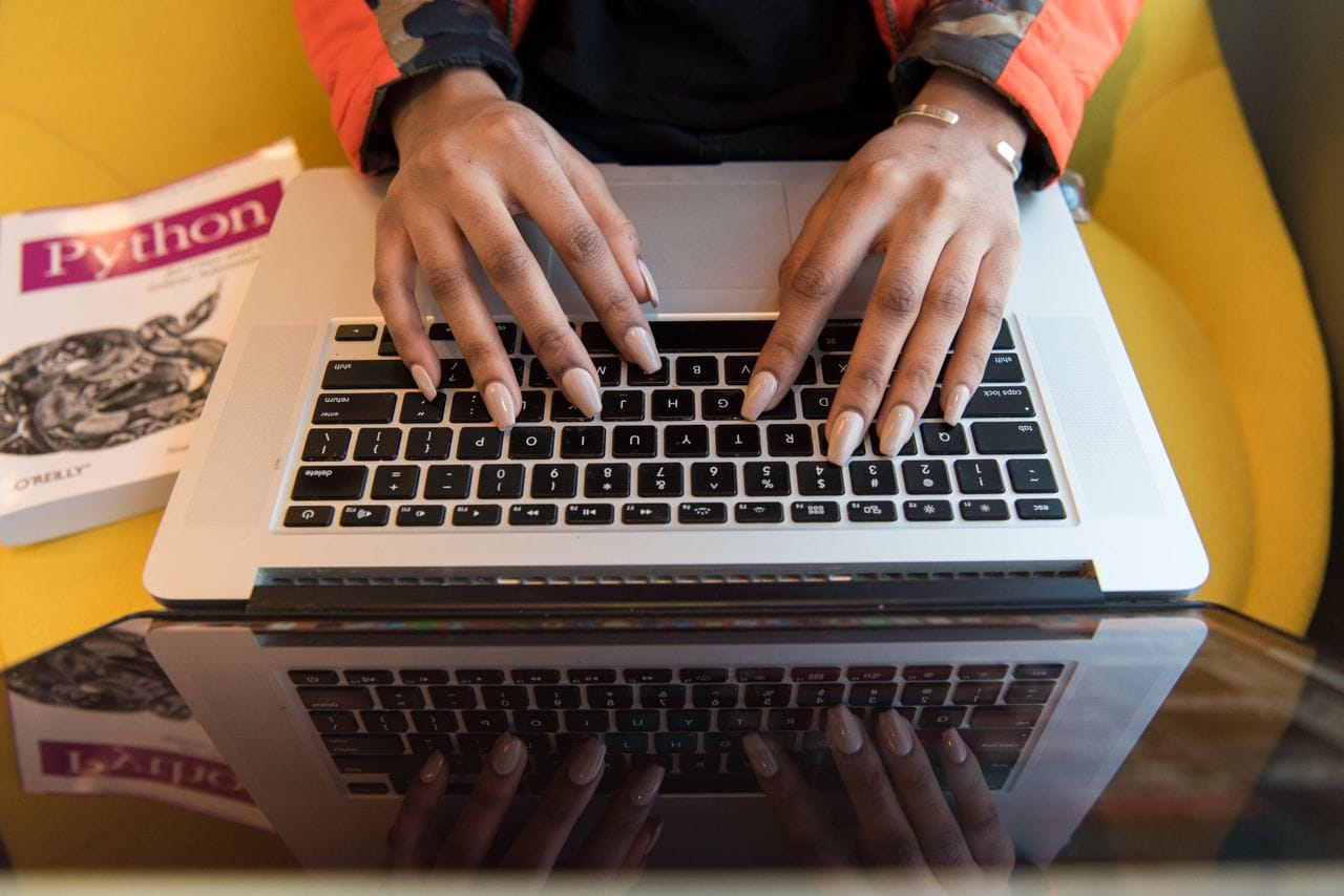 A person typing on a laptop